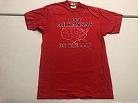 Full front view of red vintage Arkansas T-shirt laid flat, showing text and map graphic.