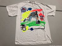 Front view of white T-shirt with Toronto 1991 All-Star Game theme and colorful paint splatters with a baseball infielder graphic.