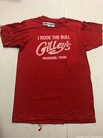 Red vintage Gilley's T-shirt laid flat, full front view showing printed text and general condition.