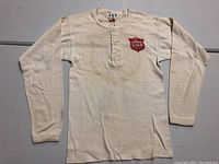 Front view of vintage cream long-sleeve jersey with button placket and Lone Star Beer logo on chest.