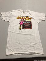 Full front view of the white vintage Mabel's Cat House T-shirt with a graphic and text print.