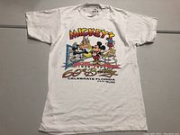 Full front view of white vintage Mickey Mouse 60th Birthday T-shirt laid flat.