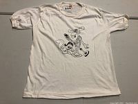 Full view of the vintage white T-shirt with black print of Rocky and Bullwinkle characters in front.