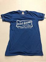 Blue vintage T-shirt laid flat displaying full front side with white screen print logo 'Trail Blazer Auto & Truck Stop' and location 'Lr. Debert, Nova Scotia'.