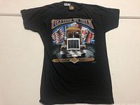 Full front view of black vintage T-shirt with truck and flags graphic and 'Together We Truck' text.