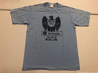 Full front view of the light blue T-shirt showing the American Eagle and 76 Auto/Truck Stop graphic.