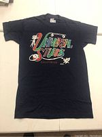 Full front view of the black Universal Studios T-shirt showing the entire graphic design and overall condition of the shirt.