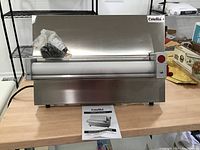 Front view of stainless steel dough sheeter with roller and control knob