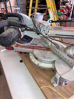 Side view showing handle, blade guard, sliding mechanism and rails