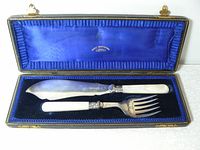 Vintage Henry Birks & Sons serving set displayed in original blue lined box with gold clasps, showing both knife and fork.