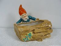 Front and top view of vintage ceramic leprechaun planter, showing the log planter opening and the leprechaun figure.