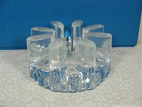 Front angle view showing the spaced oval candle slots and textured clear glass.