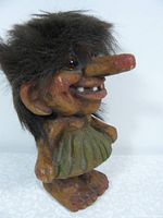 Front view of Norwegian troll figurine with detailed face and hair