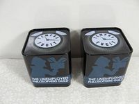 Pair of square black metal cases with 'TEMPUS FUGIT' and Unemployed Philosophers Guild branding.