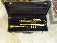 Vintage Bundy trumpet in open black hard case showing entire instrument