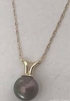 Close-up of pendant bale and Tahitian pearl on chain