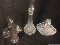 Photo showing the tall crystal vase and two smaller handled bowls with etched designs.