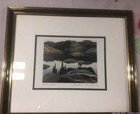 Framed art print "Mirror Lake" showing the full artwork in frame with reflection visible.