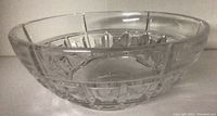 Side view of the clear crystal bowl showing geometric cut pattern and shape.