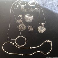 Sterling silver rings, necklaces, charms including Bermuda token and heart pendant.