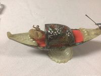 Side view of gondola showing mother of pearl inlay, ballerina figure, and the gondola's overall shape and materials