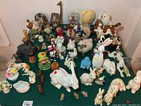 Wide shot of all animal figurines including Kachina, rabbits, owls, giraffe, dogs, birds and more on display.