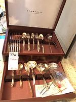 Full view of 1847 Rogers Bros IS Flair flatware set in a wooden case with all items arranged in slots.