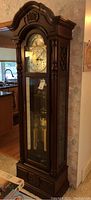 Front view of wooden grandfather clock showing full height and overall condition