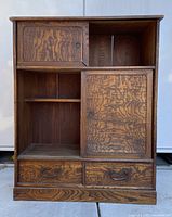 Front view with left top sliding door open revealing interior shelf and right sliding door closed, two bottom drawers visible