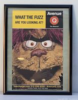 Framed Avenue Q musical poster front view showing character image and multiple autographs
