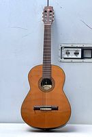 Full view of the vintage Conn acoustic guitar showing the front wooden body and neck, sitting upright.