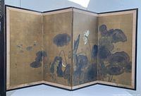 Front view of the 4-panel Japanese folding screen showing lotus flower painting on gold background with signs of wear and some damage.