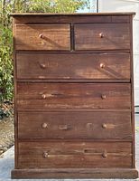 Front view of mesquite wood 6 drawer chest showing drawer layout and condition.