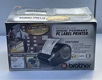 Box front showing Brother QL-1050 wide format PC label printer model with product features and usage examples.