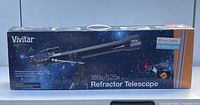 Photo of the box featuring Vivitar 168x/525x refractor telescope with 60mm lens and 3x Barlow lens, showing new sealed packaging.