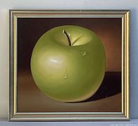 Front view of oil painting showing a green apple with water droplets in a gold frame.