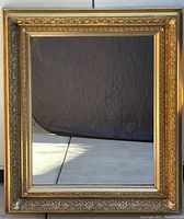 Full view of the rectangular Victorian carved gilt frame with mirror inside, showing overall design and condition.