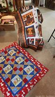 Throws displayed in living room setting draped over chair and laid flat on the floor showing designs and size