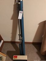 Photo of the Da-Lite projection screen in blue carrying case with label showing lot number