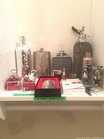 Overall grouping of all flasks, siphon, shaker, openers, whiskey stones, bowl, cutter
