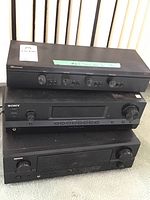Stacked Russound SDB-4.1, Sony STR-DH130, and Denon DRA-397 units showing front panel details and general condition.