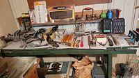 wide view of bench showing assorted tools arranged on shelf and tabletop