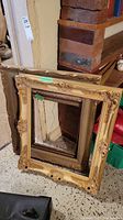 Three vintage picture frames stacked together showing sizes and styles