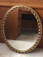 Full frontal image of the oval mirror showing its size and reflection.