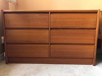 Front view of Canadian teak 6 drawer dresser showing even wood grain and simple drawer fronts.