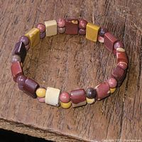 Close-up image of the bracelet on wooden background showing the various colored stone beads.