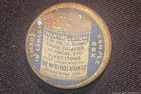 Close-up image of the small antique Mentholatum tin showing label details and condition