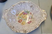 Top view of octagonal antique English pottery bowl showing floral decoration with gold accents and crackled glaze.