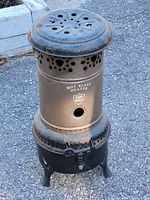 Front view of the vintage Hot Blast GSW kerosene heater showing cylindrical metal body with ventilation holes and branded text.