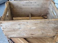 Side view showing crate construction and stamp 'PROPERTY OF GIESEBRECHTS LTD' inside.